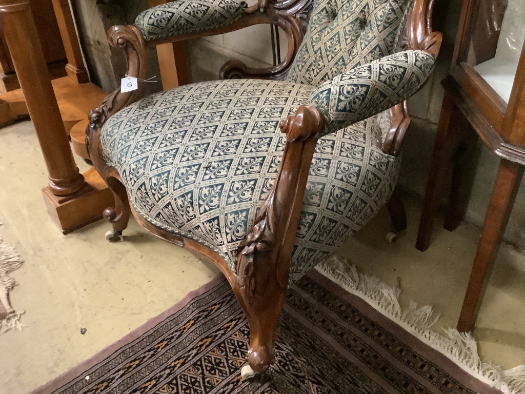 A Victorian carved walnut open armchair, width 66cm depth 75cm height 96cm